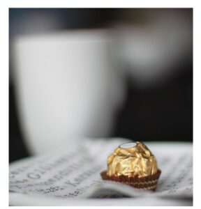 Woman savoring a single chocolate truffle with calm delight, symbolizing Venus energy and the art of moderation